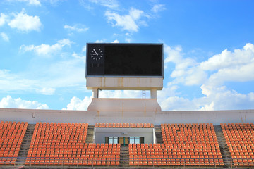 row of orange seats and score board