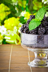 Sweet fresh fruits in glass goblet with mint leaf