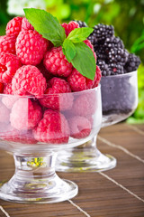 Sweet fresh fruits in glass goblet with mint leaf