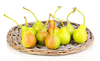 ripe pears on wicker mat isolated on white.