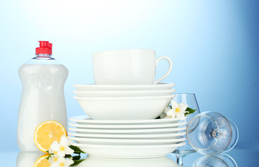 empty clean plates, glasses and cups with dishwashing liquid