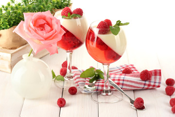 fruit jelly with raspberries in glasses on wooden table
