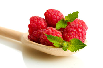 ripe raspberries with mint in wooden spoon isolated on white