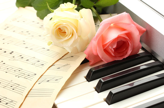 background of piano keyboard with roses