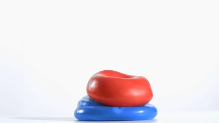 Red balloon rebounding in super slow motion on a blue one - Powered by Adobe