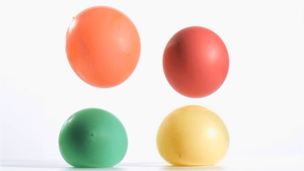 Two balloons falling in super slow on others - Powered by Adobe