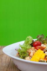 Salad in a bowl on green background