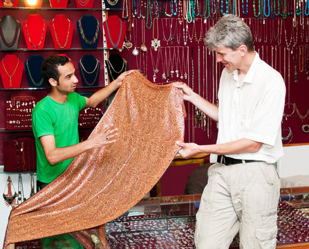 tourist buys fabric in India