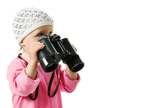 girl in  pink dress with a pair of binoculars