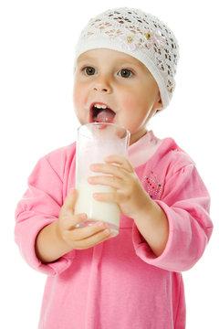 Pretty Little Girl Is Holding A Glass Of Milk