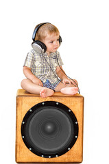 Portrait of child in earpiecess sitting on subwoofer