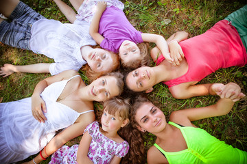 Fototapeta premium group of girls teenagers in park on grass