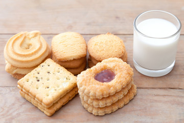 Milk with cookie on wood table