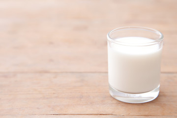 Milk on wood table background