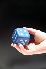 hand of a person giving a dice