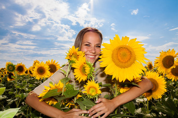 woman on blooming sunflower field