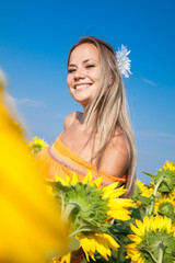 Happy girl in sunflower field