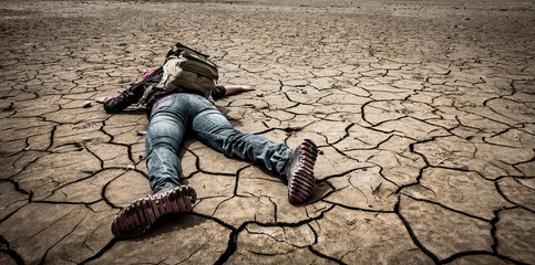Fototapeta person lays on the dried ground obraz