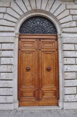 Fototapeta na wymiar Wooden door and a stone wall, buildings Tuscany