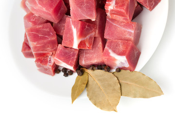 pieces of frozen meat with laurel leaves isolated