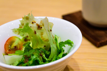 Japanese salad style with tomato and iceberg lettuce.