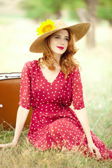 Redhead girl with sunflower at outdoor.