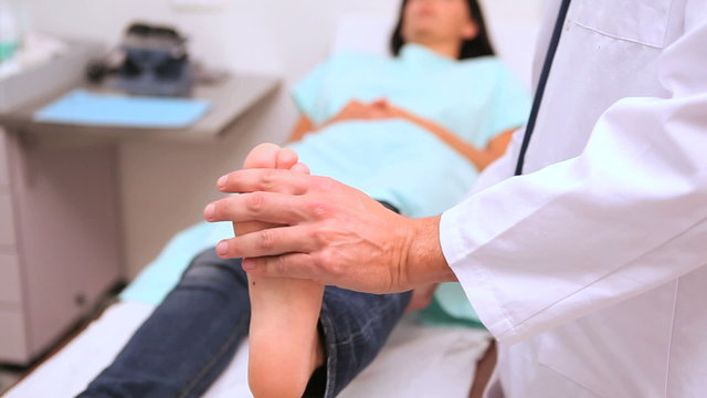 Doctor manipulating  foot of a patient