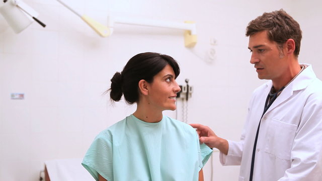 Doctor touching the neck of a patient
