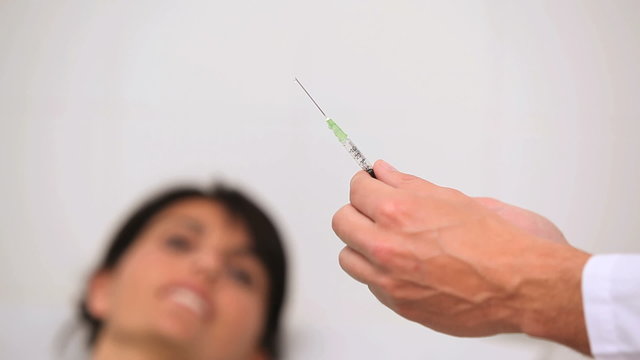 Doctor preparing an injection for a patient