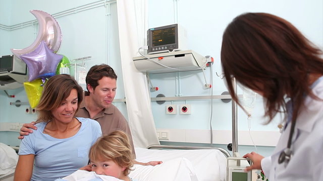 Smiling parents next to a doctor