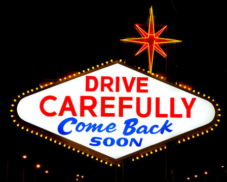 The reverse of the Las Vegas sign reading "Drive Carefully"