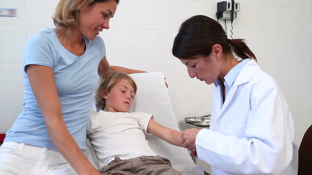 Child looking at his bandage