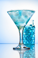 Martini glass with ice blue cocktail