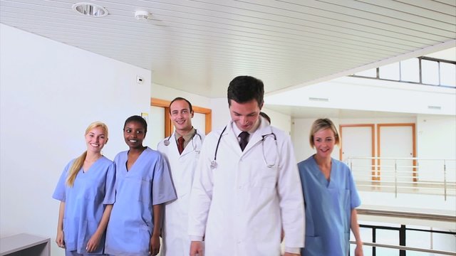Doctors with nurses walking