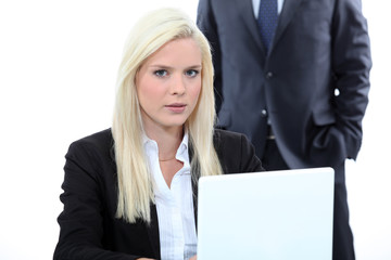 Blonde woman and a man behind