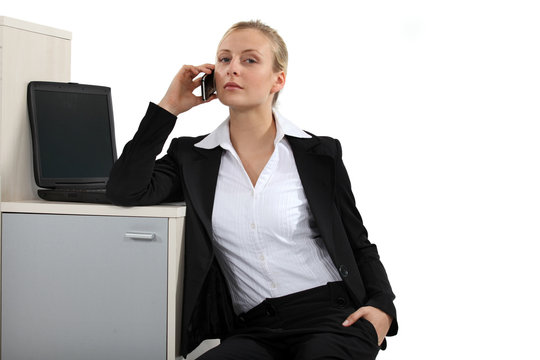 Serious blond businesswoman making a call