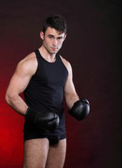 Portrait sportsman boxer in studio dark background