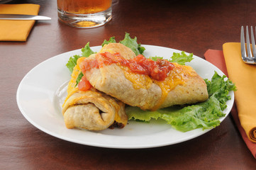 Chimichangas topped with cheddar cheese