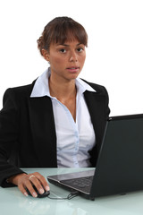 sweet-looking businesswoman working on laptop