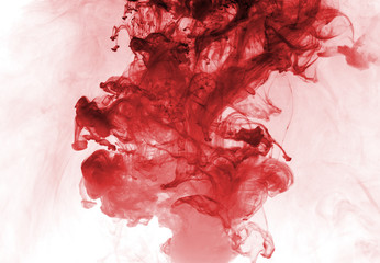 Red ink in water on a white background.