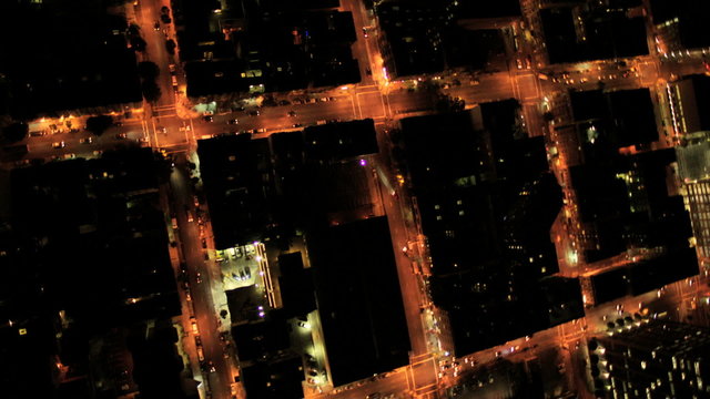 Aerial night vertical city view of rolling road grid system, USA