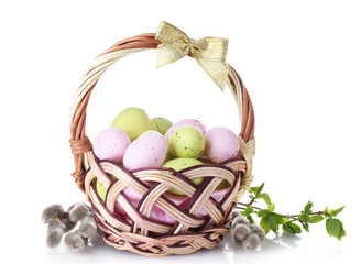 basket with Easter eggs and pussy-willow twigs isolated on