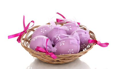 Colorful easter eggs in basket isolated on white