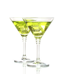 Yellow cocktail in martini glasses isolated on white