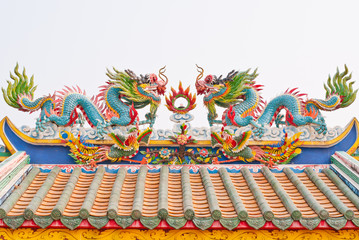 Statue of twin dragons on the roof of Chinese temple