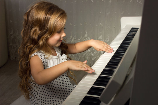blond girl playing a piano
