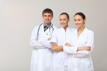 Fototapeta premium Three young doctor in white uniform