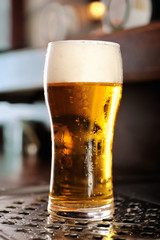 Glass of beer close-up with froth