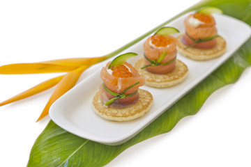Red salmon roll with chees, caviar and cucumber