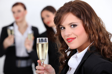 three businesswomen drinking champagne